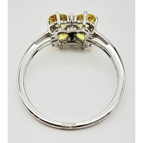 643 - A 9K WHITE GOLD YELLOW SAPPHIRE RING ADORNED WITH WHITE ZIRCONIA , COMES WITH CERTIFICATE OF AUTHENT... 