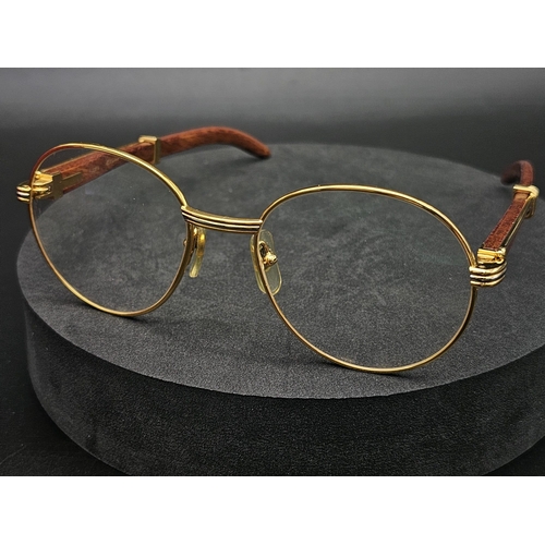 A PAIR OF CARTIER GLASSES WITH THE DISTINCTIVE DESIGNER LOOK IN