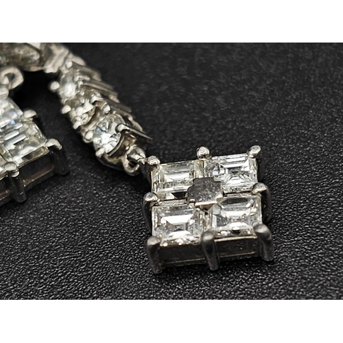 162 - A SUPERB PAIR OF DIAMOND DROP EARRINGS SET IN PLATINUM .  4.6gms   3cms DROP     ref 13069