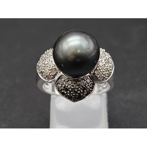 64 - An 18K White Gold, Diamond and Tahitian South Sea Pearl Ring. Large, beautiful central pearl (12mm) ... 