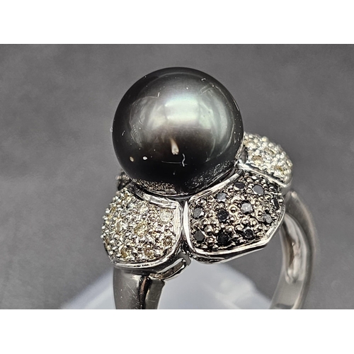 64 - An 18K White Gold, Diamond and Tahitian South Sea Pearl Ring. Large, beautiful central pearl (12mm) ... 