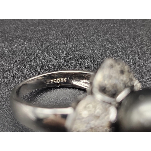 64 - An 18K White Gold, Diamond and Tahitian South Sea Pearl Ring. Large, beautiful central pearl (12mm) ... 