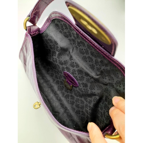 753 - A Mulberry Purple Leather Baguette Handbag. 24cm x 12cm.
Ref: 13004