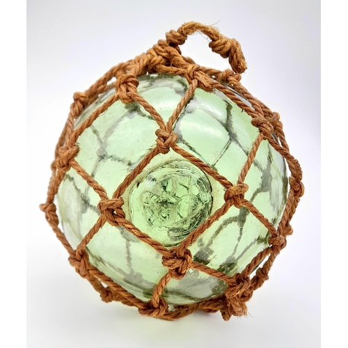 907 - An Antique Japanese Glass Fishing Float with a Lovely Pontil Mark and Netting.