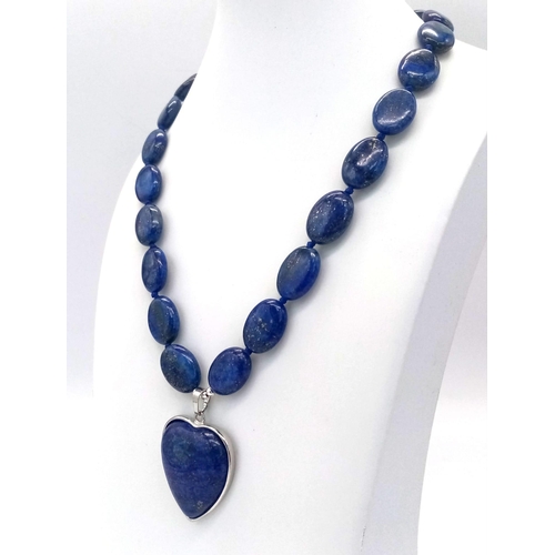 914 - A Lapis Lazuli Heart Pendant on a Lapis Lazuli Oval Bead Necklace. 4cm and 46cm. Oval beads - 17mm.