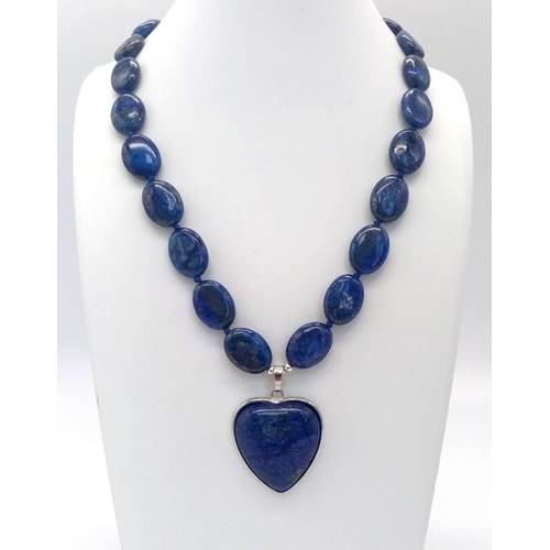 914 - A Lapis Lazuli Heart Pendant on a Lapis Lazuli Oval Bead Necklace. 4cm and 46cm. Oval beads - 17mm.