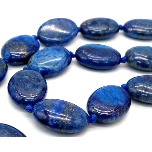 914 - A Lapis Lazuli Heart Pendant on a Lapis Lazuli Oval Bead Necklace. 4cm and 46cm. Oval beads - 17mm.
