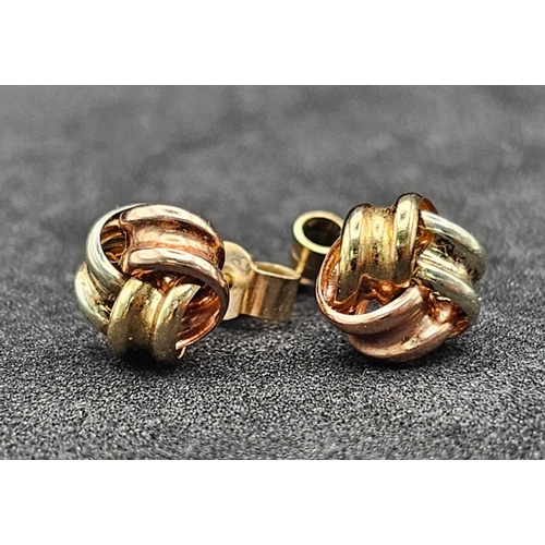 1322 - A Pair of Tri-Colour 9k Gold Knot Stud Earrings. 0.75g total weight.