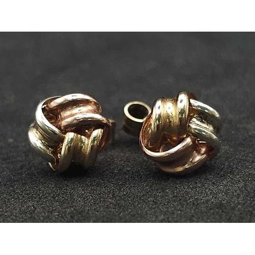 1322 - A Pair of Tri-Colour 9k Gold Knot Stud Earrings. 0.75g total weight.