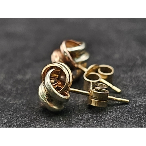 1322 - A Pair of Tri-Colour 9k Gold Knot Stud Earrings. 0.75g total weight.