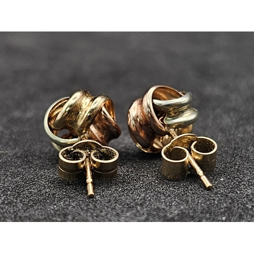 1322 - A Pair of Tri-Colour 9k Gold Knot Stud Earrings. 0.75g total weight.