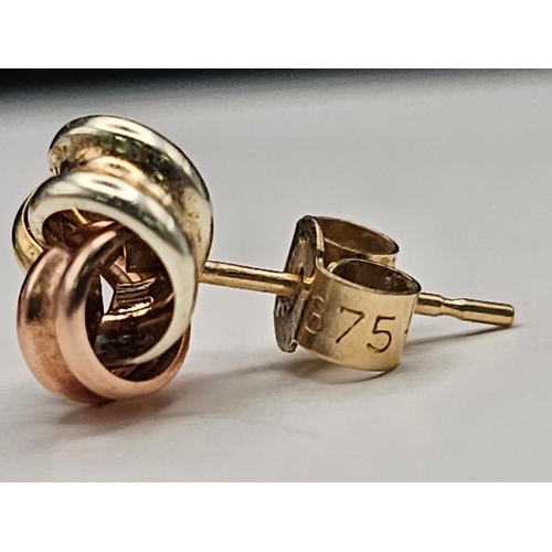 1322 - A Pair of Tri-Colour 9k Gold Knot Stud Earrings. 0.75g total weight.