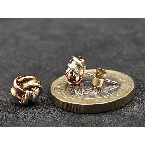 1322 - A Pair of Tri-Colour 9k Gold Knot Stud Earrings. 0.75g total weight.
