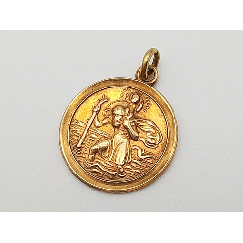 1228 - A Vintage 9K Yellow Gold St. Christopher Pendant. 14mm diameter. 1.77g