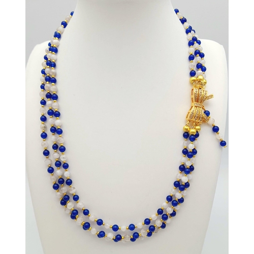 117 - A very feminine, necklace and earrings set consisting of three rows of modern Sri Lankan round blue ... 