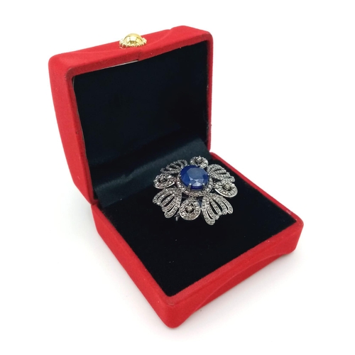 222 - A 10.75ct Blue Sapphire Gemstone Ring with 1.65ct Diamond Accents. Set in 925 Silver. Size N. 10.78g... 