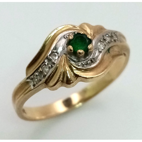 18 - A 9K Yellow Gold Emerald and Diamond Swirl Decorative Ring. Size O. 2.2g total weight.