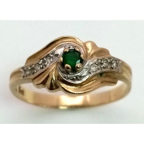 18 - A 9K Yellow Gold Emerald and Diamond Swirl Decorative Ring. Size O. 2.2g total weight.