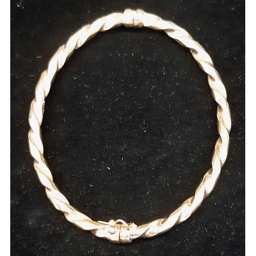 22 - A Vintage 9K Yellow Gold Twist Bangle with Clip-Open Clasp and Tension Features. 5.11g