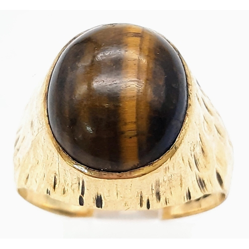 44 - A Vintage 9K yellow Gold Tigers Eye Ring. A rich, clean, tigers eye central cabochon set between bar... 