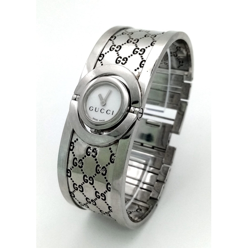 A stainless steel ladies GUCCI TWIRL 112 bangle watch. Case 17mm revolving on a horizontal axis b