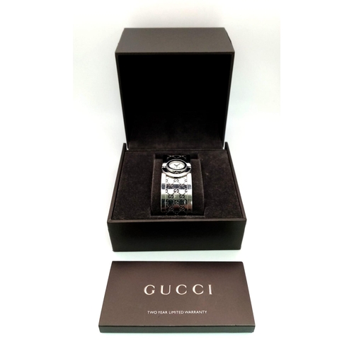 161 - A stainless steel, ladies GUCCI TWIRL 112 bangle-watch. Case 17mm, revolving on a horizontal axis, b... 