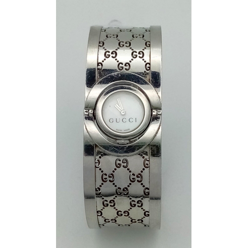 161 - A stainless steel, ladies GUCCI TWIRL 112 bangle-watch. Case 17mm, revolving on a horizontal axis, b... 