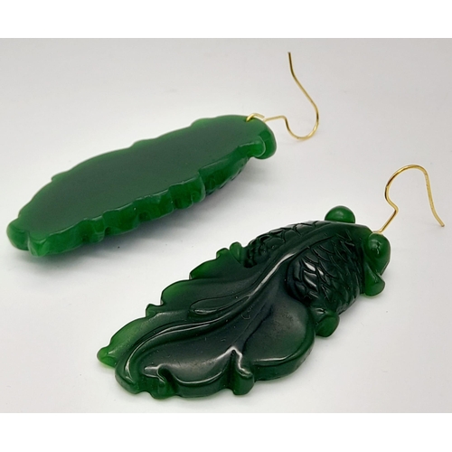 217 - A Chinese, green jade necklace and earrings set with large fancy tailed fish pendants, symbolising l... 