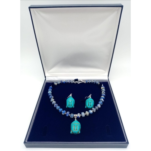 231 - A lapis lazuli necklace with a turquoise Buddha head pendant, accompanied by matching earrings. Neck... 
