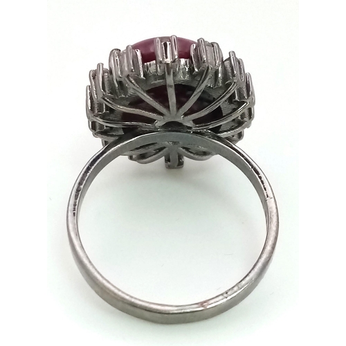 198 - A 13.2ct Madagascan Oval Cut Ruby and Rose cut Diamond Surround Ring - 0.65ct. Set in 925 silver. Si... 