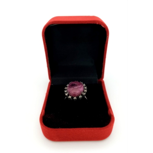 198 - A 13.2ct Madagascan Oval Cut Ruby and Rose cut Diamond Surround Ring - 0.65ct. Set in 925 silver. Si... 