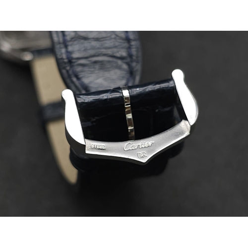 24 - A Cartier Santos Damont Watch. Black leather Cartier strap. Steel case - 32mm. Silver tone dial. Dia... 