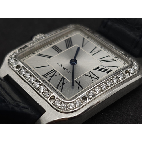 24 - A Cartier Santos Damont Watch. Black leather Cartier strap. Steel case - 32mm. Silver tone dial. Dia... 