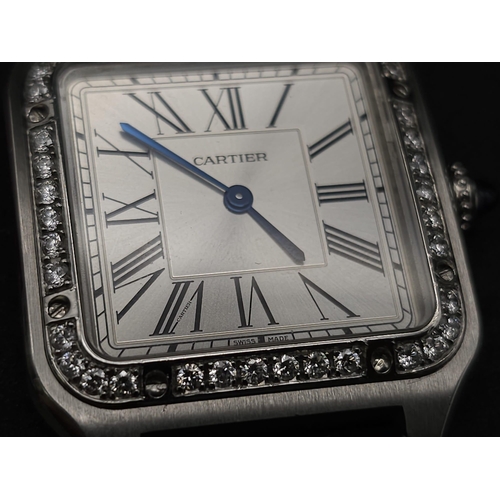 24 - A Cartier Santos Damont Watch. Black leather Cartier strap. Steel case - 32mm. Silver tone dial. Dia... 