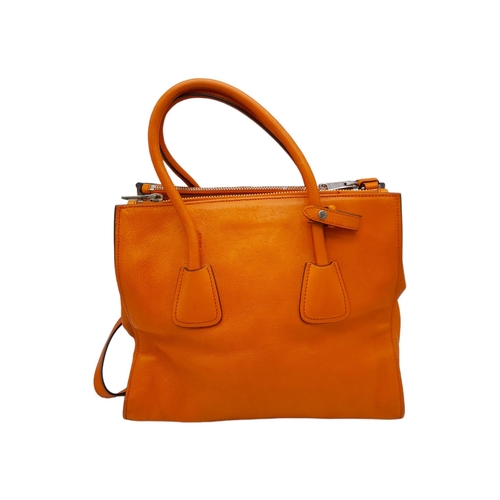 192 - A Prada Saffiano Double Zip Luxury Tote Bag. Burnt orange leather with silver tone hardware. Spaciou... 