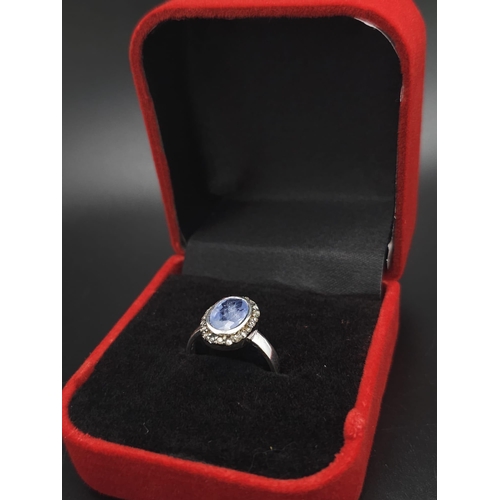 74 - A 1.84ct Oval Cut Blue Sapphire ring with Rose-Cut Diamond Surround - 0.16ct. Set in 925 silver. Siz... 