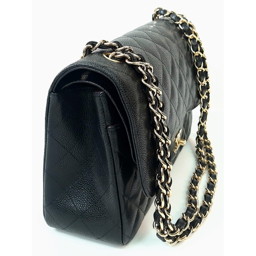 31 - A Classic Chanel Jumbo Flap Bag. Black quilted caviar leather. Gold tone CC logo clasp. Entwined adj... 