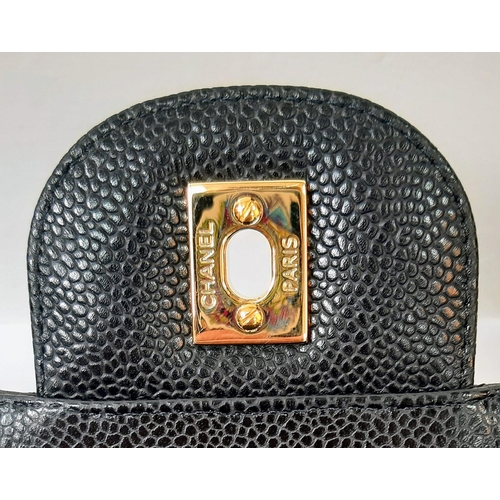 31 - A Classic Chanel Jumbo Flap Bag. Black quilted caviar leather. Gold tone CC logo clasp. Entwined adj... 