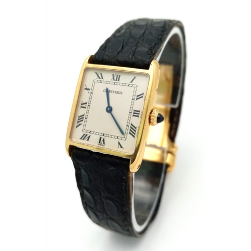 127 - A Vintage Cartier 18k Gold Unisex Tank Watch. Black leather strap. 18K gold case - 23mm width. White... 