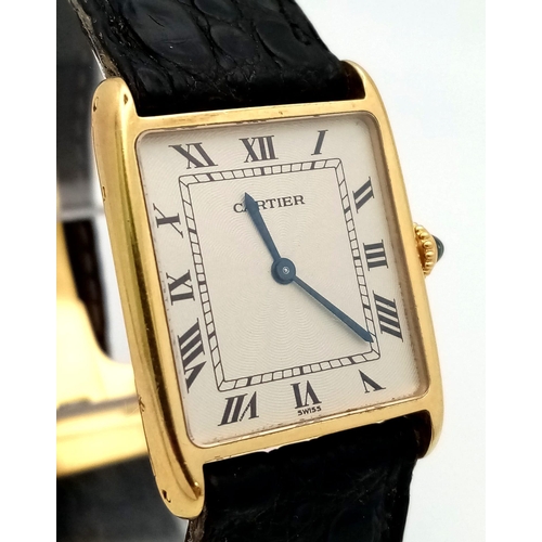 127 - A Vintage Cartier 18k Gold Unisex Tank Watch. Black leather strap. 18K gold case - 23mm width. White... 