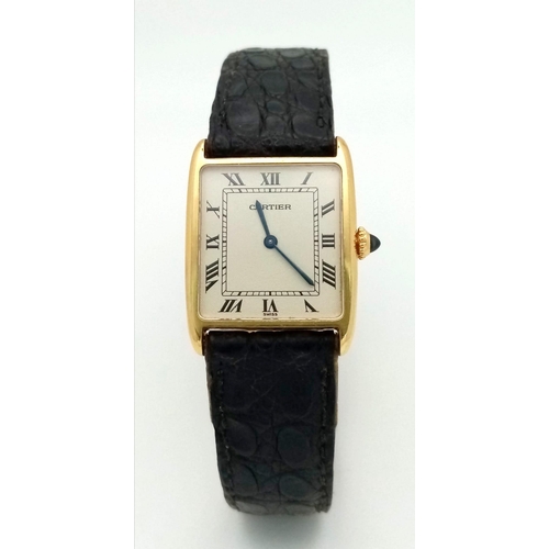 127 - A Vintage Cartier 18k Gold Unisex Tank Watch. Black leather strap. 18K gold case - 23mm width. White... 