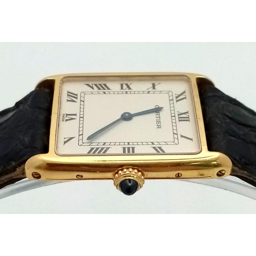 127 - A Vintage Cartier 18k Gold Unisex Tank Watch. Black leather strap. 18K gold case - 23mm width. White... 