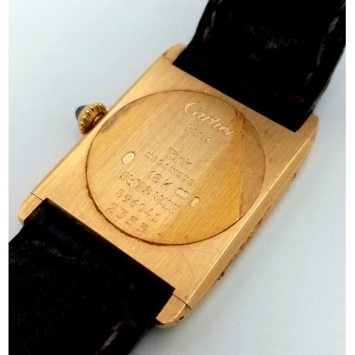 127 - A Vintage Cartier 18k Gold Unisex Tank Watch. Black leather strap. 18K gold case - 23mm width. White... 