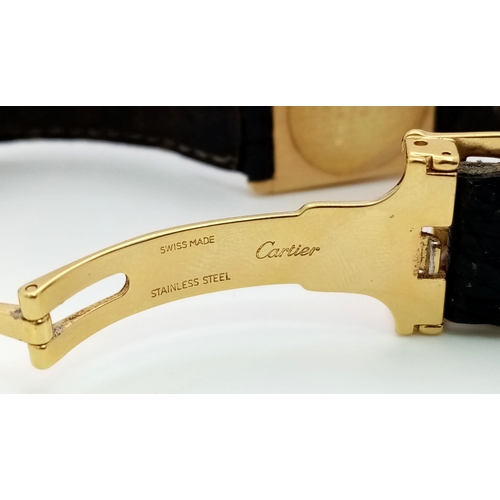 127 - A Vintage Cartier 18k Gold Unisex Tank Watch. Black leather strap. 18K gold case - 23mm width. White... 