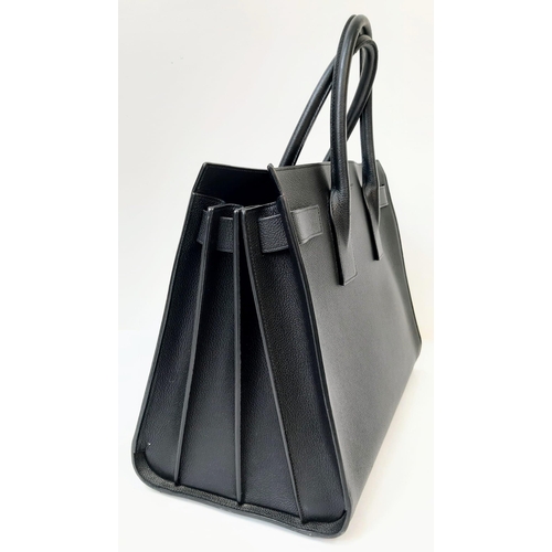 164 - A Classy YSL Black Leather Sac de Jour Tote Bag. Textured calf leather exterior with twin handles. S... 