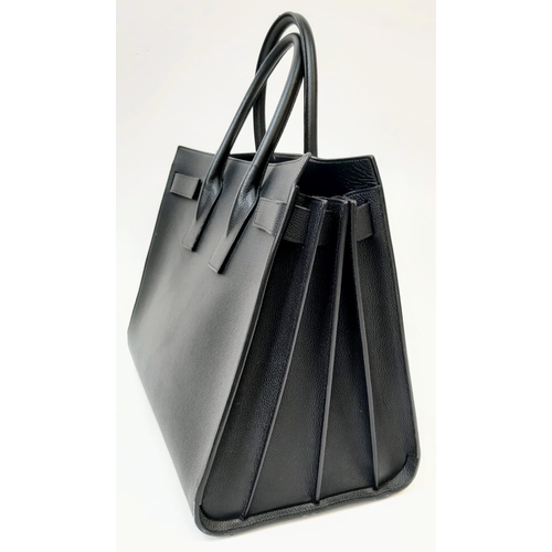 164 - A Classy YSL Black Leather Sac de Jour Tote Bag. Textured calf leather exterior with twin handles. S... 