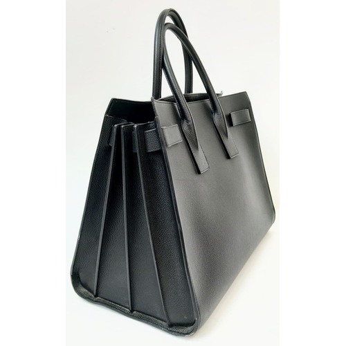 164 - A Classy YSL Black Leather Sac de Jour Tote Bag. Textured calf leather exterior with twin handles. S... 