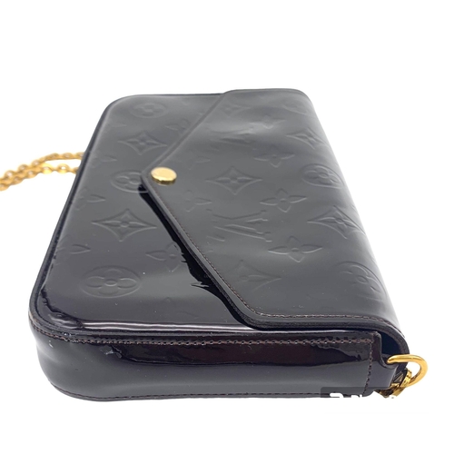 185 - A Louis Vuitton Burgundy Patent Leather Bag. Monogram exterior with gilded handle. Textile interior ... 