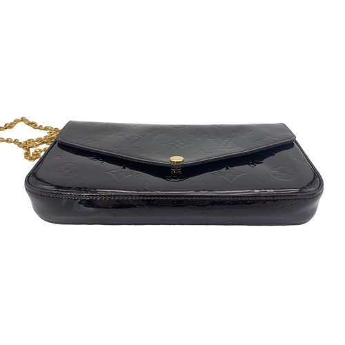 185 - A Louis Vuitton Burgundy Patent Leather Bag. Monogram exterior with gilded handle. Textile interior ... 