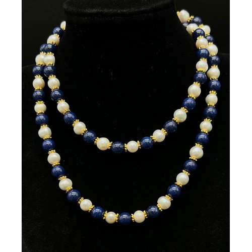 319 - A Lapis Lazuli and Cultured Pearl Matinee Length Necklace. 8mm lapis and pearls. Gilded spacers and ... 